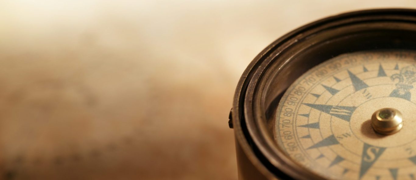 A compass on a faded sepia background 
